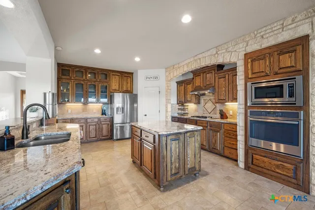 a bathroom with a tub a sink a mirror and a shower