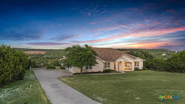 a view of a hallway with windows and chandelier