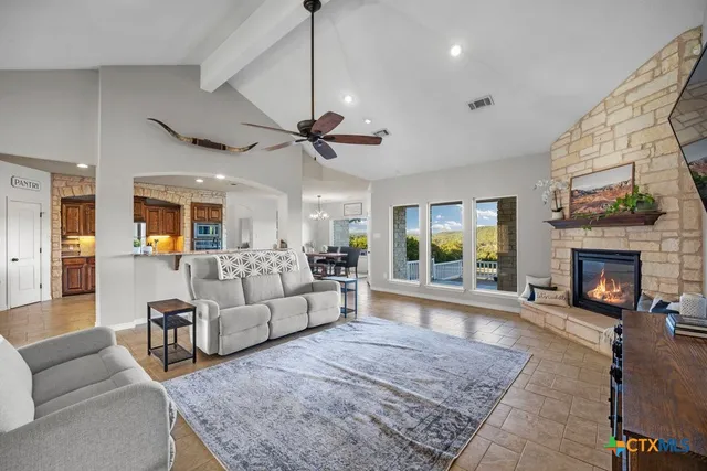 a kitchen with kitchen island granite countertop a stove and cabinets