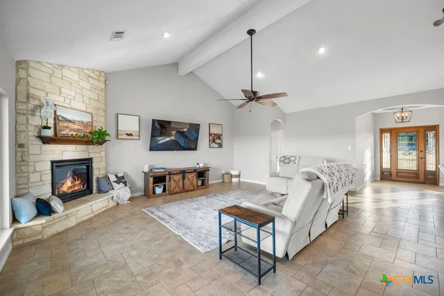 a kitchen with stainless steel appliances granite countertop a sink a stove and a refrigerator