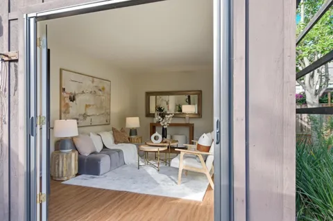 a view of a bedroom with a bed and glass door