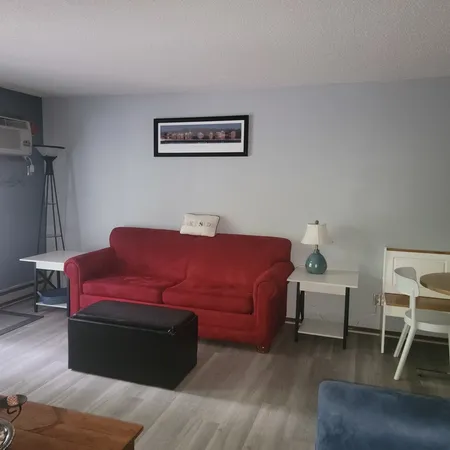 a bedroom with a bed and a chair