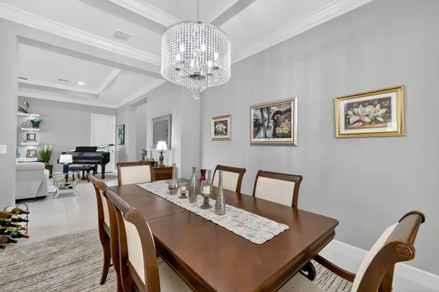 a kitchen with a stove a sink a microwave a dining table and chairs