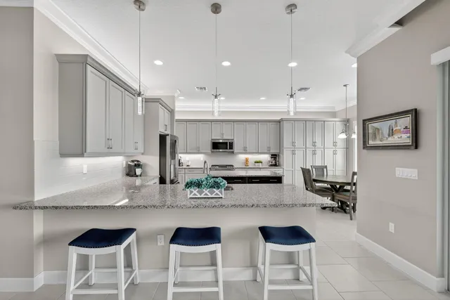 a living room with furniture chandelier and a large window
