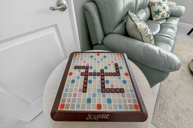 a living room with stainless steel appliances kitchen island granite countertop a large window