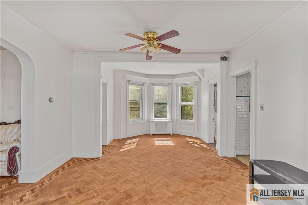 216 Handy Street New Brunswick, NJ 08901 - Photo 12 of 34 a view of a livingroom with a ceiling fan and window