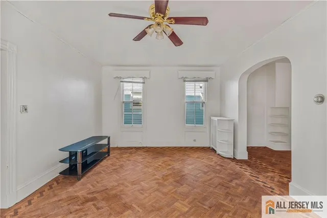 a view of room with window and ceiling fan