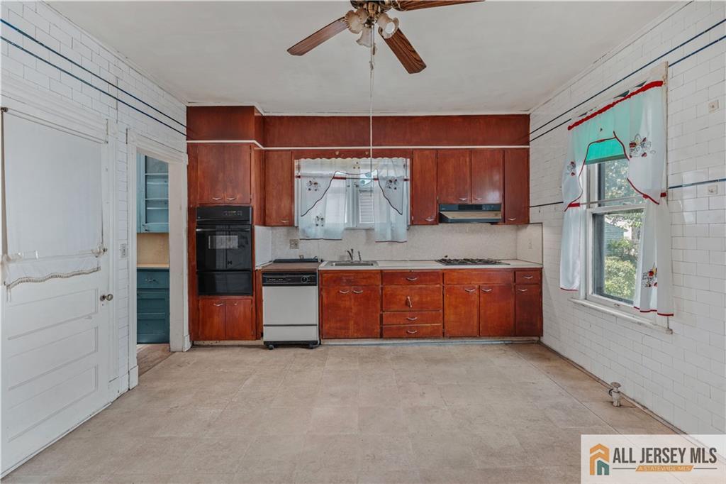 216 Handy Street New Brunswick, NJ 08901 - Photo 16 of 34 a large kitchen with stainless steel appliances granite countertop a stove a sink and a refrigerator