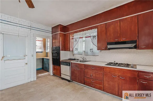 a kitchen with stainless steel appliances granite countertop a sink and cabinets