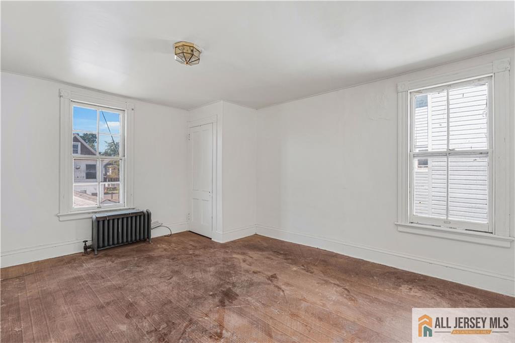 216 Handy Street New Brunswick, NJ 08901 - Photo 27 of 34 a bedroom with a bed and window
