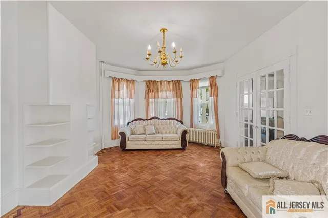 a living room with furniture and a chandelier