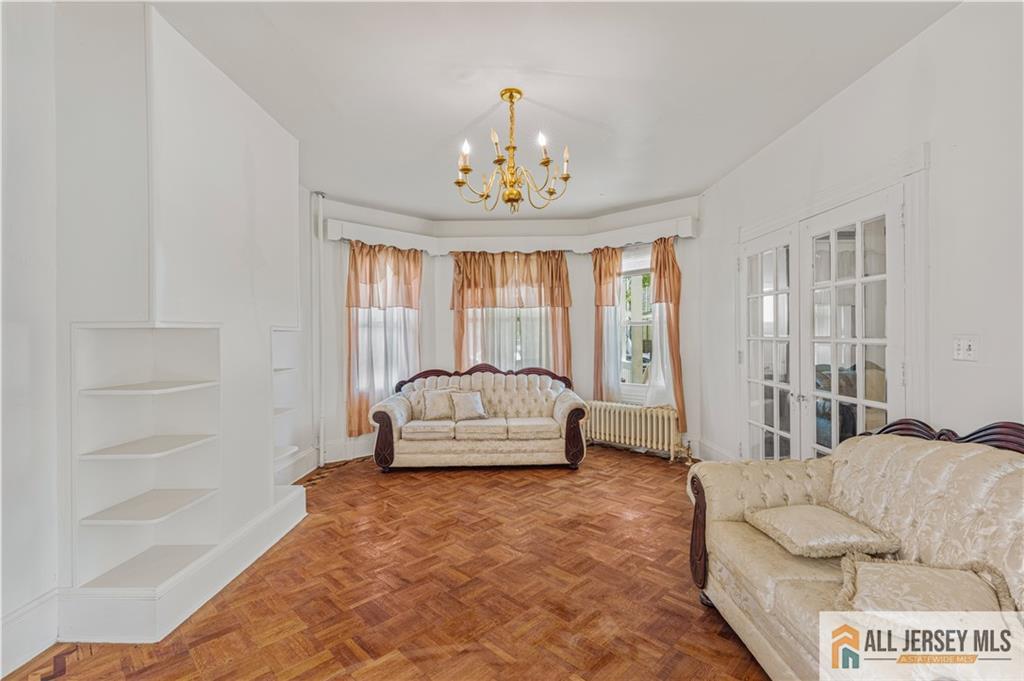 216 Handy Street New Brunswick, NJ 08901 - Photo 10 of 34 a living room with furniture and a chandelier
