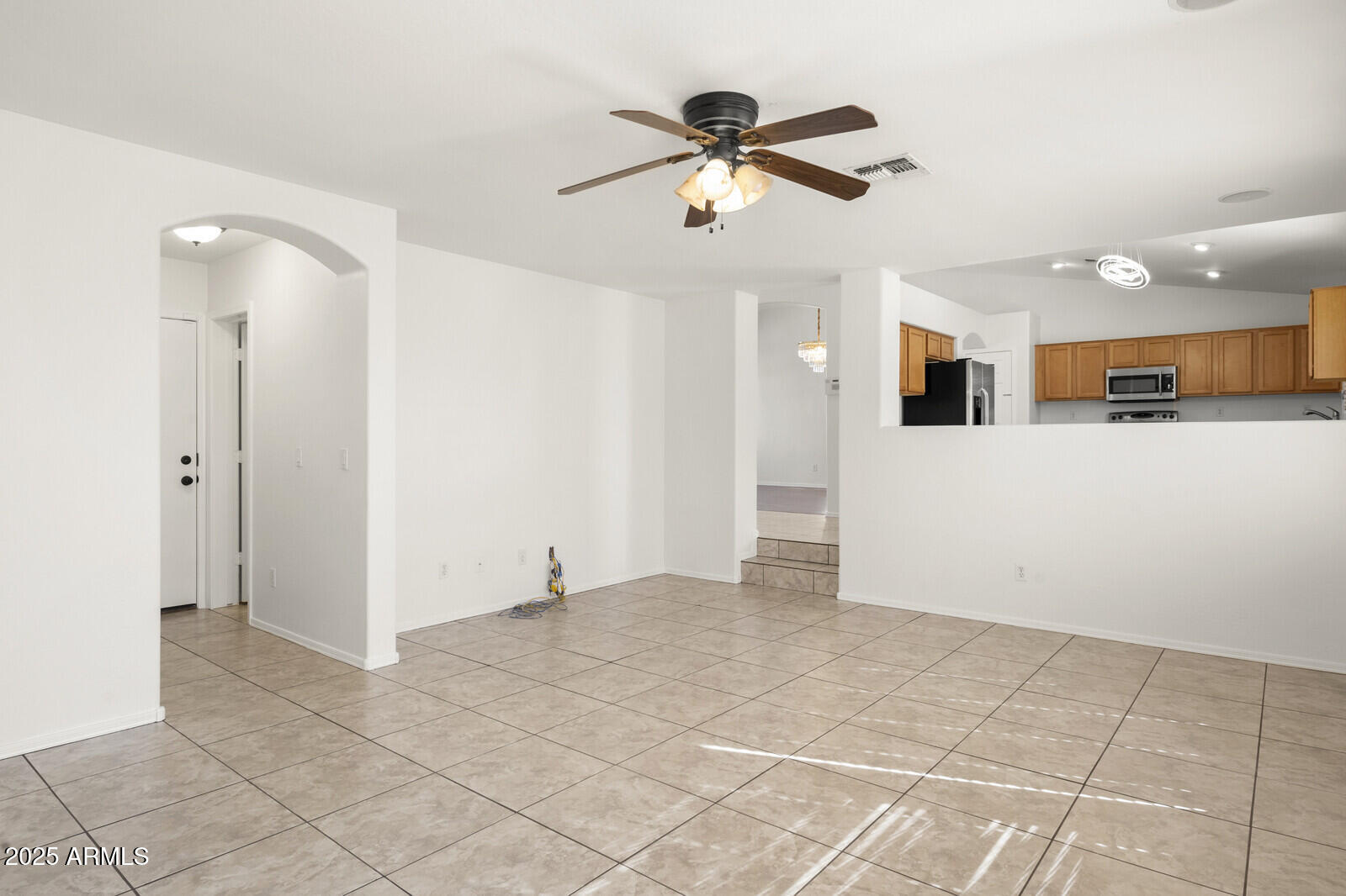 3297 East Warbler Road Gilbert, AZ 85297 - Photo 13 of 32 a view of a livingroom with a ceiling fan and window