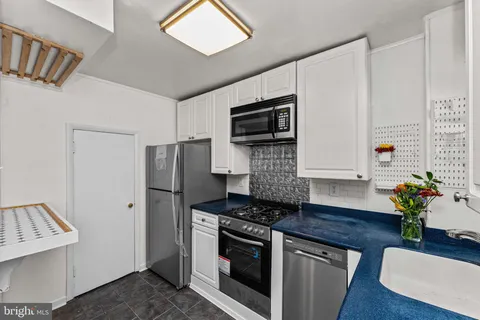 a kitchen with stainless steel appliances granite countertop a refrigerator stove and microwave
