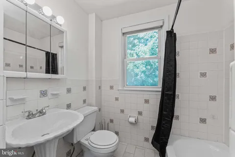 a bathroom with a sink toilet a mirror and shower