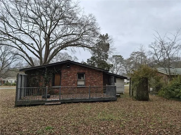 a front view of a house with parking space and trees
