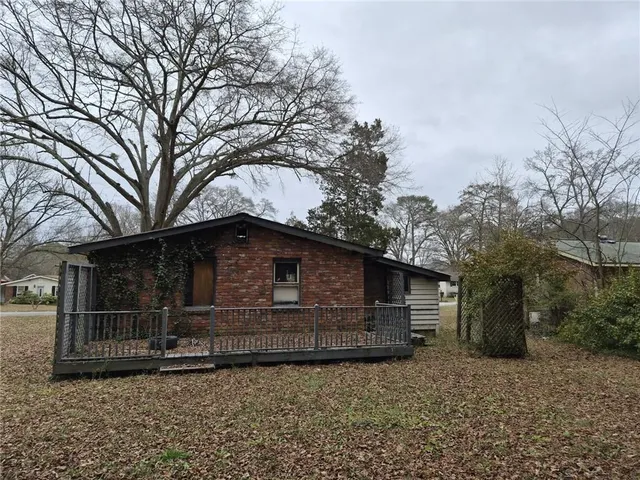 a front view of a house with parking space and trees