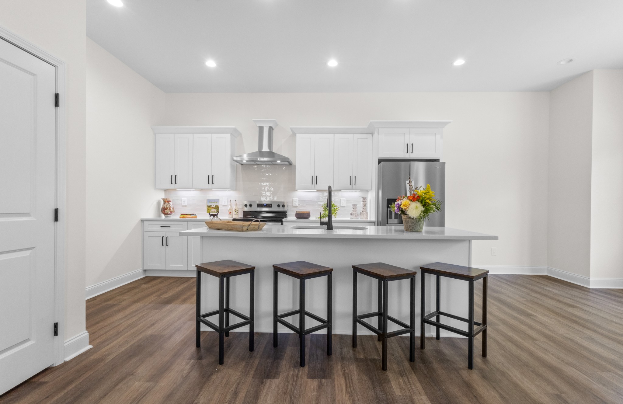 463 Centre Street Pleasant View, TN 37146 - Photo 11 of 43 a kitchen with granite countertop white cabinets and wooden floor