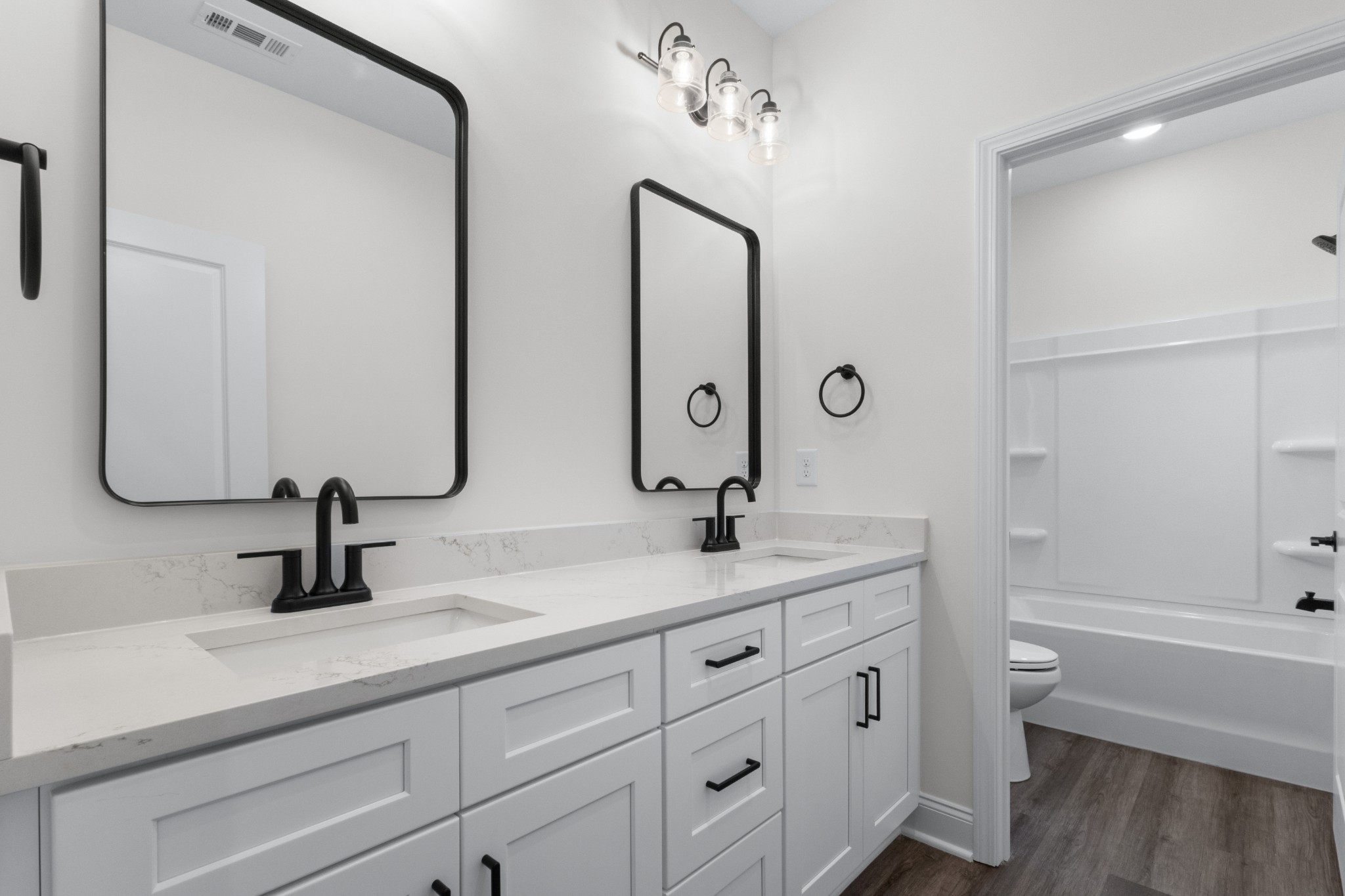 463 Centre Street Pleasant View, TN 37146 - Photo 24 of 43 a bathroom with a double vanity sink and mirror with toilet