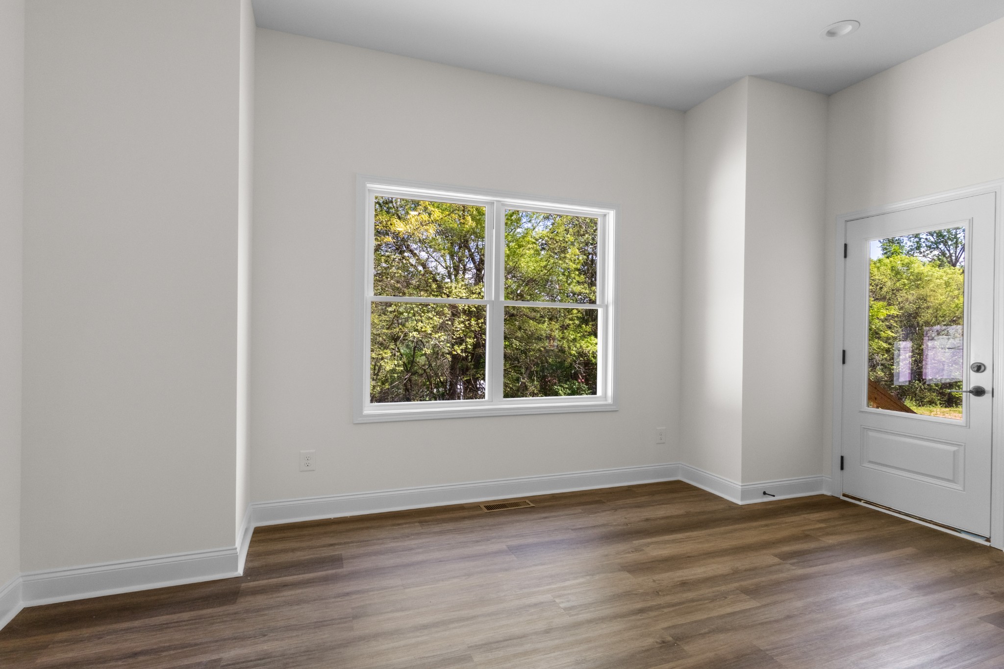 463 Centre Street Pleasant View, TN 37146 - Photo 33 of 43 an empty room with wooden floor and windows