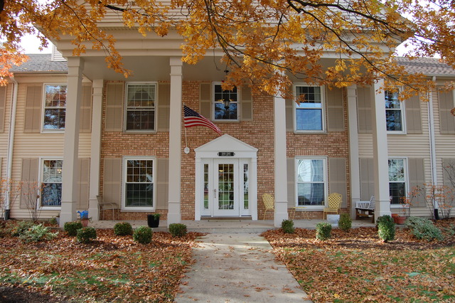 1072 Spring Garden Circle, Unit 4 Naperville, IL 60563 - Photo 1 of 18 a front view of a house with a yard