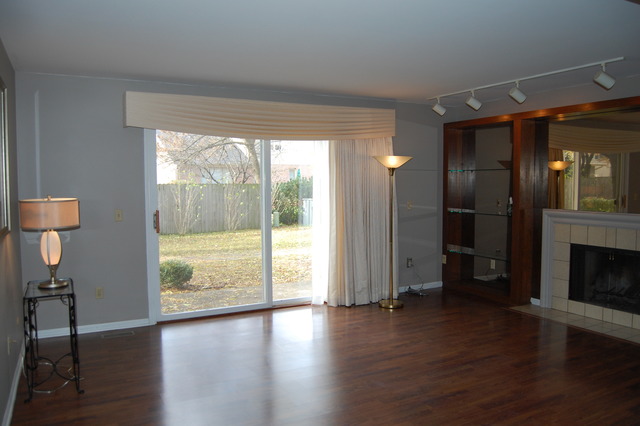 1072 Spring Garden Circle, Unit 4 Naperville, IL 60563 - Photo 2 of 18 a view of a livingroom with wooden floor a fireplace and window