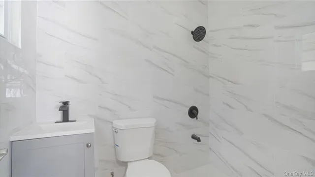 a bathroom with a toilet shower