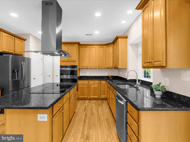 a view of a living room with kitchen island furniture and a kitchen view