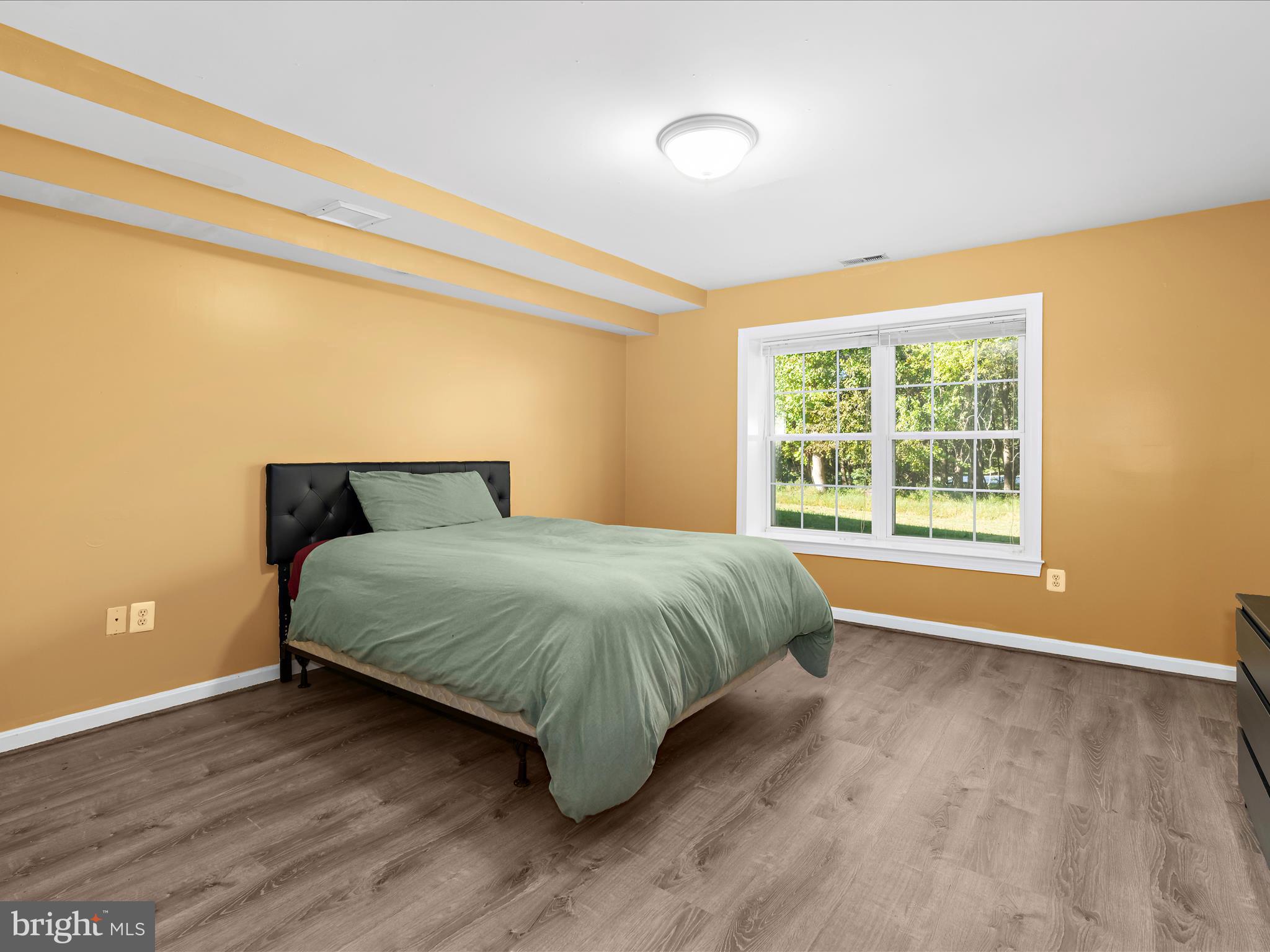 15533 Thompson Road Silver Spring, MD 20905 - Photo 29 of 76 a bedroom with a bed and wooden floor