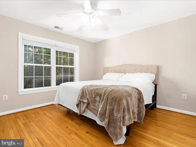 a bedroom with a bed and large window with outer view
