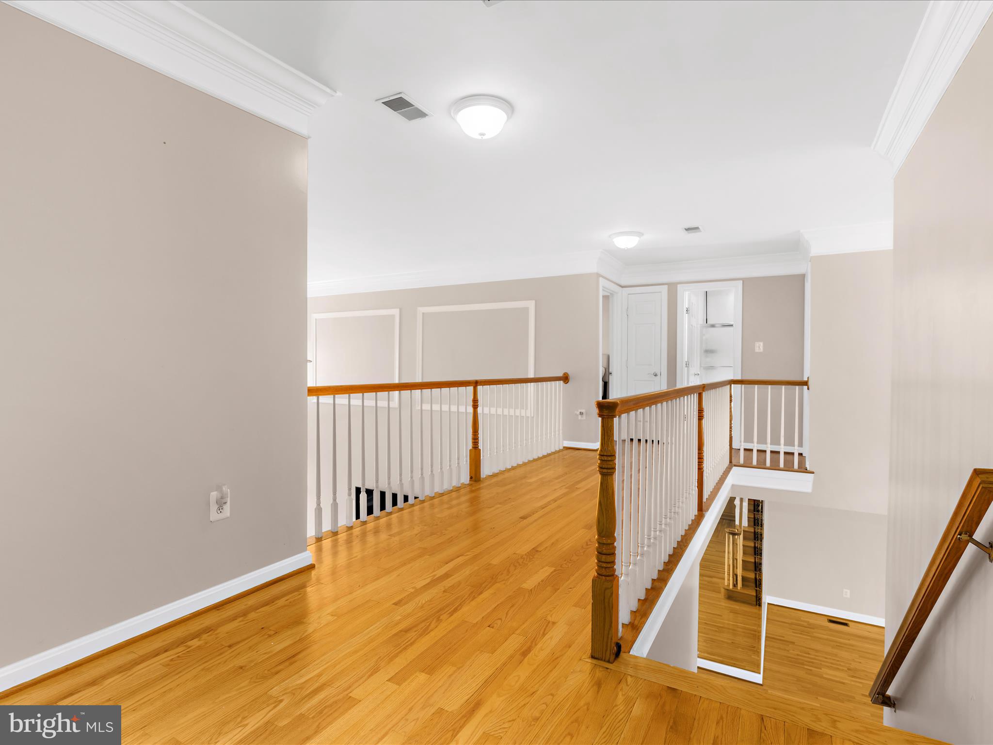 15533 Thompson Road Silver Spring, MD 20905 - Photo 45 of 76 a view of a hallway with wooden floor and staircase