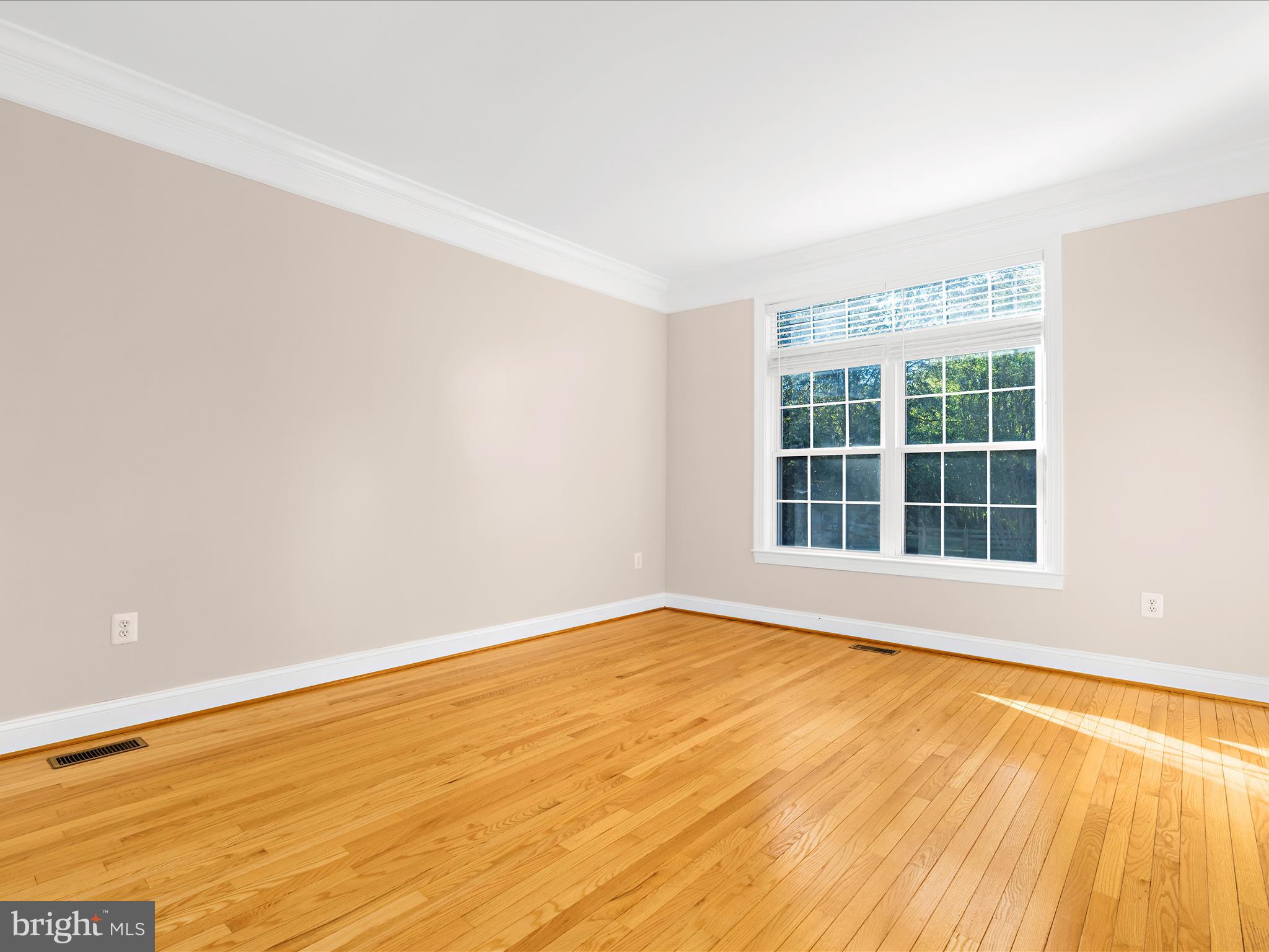 15533 Thompson Road Silver Spring, MD 20905 - Photo 48 of 76 a view of an empty room with wooden floor and a window