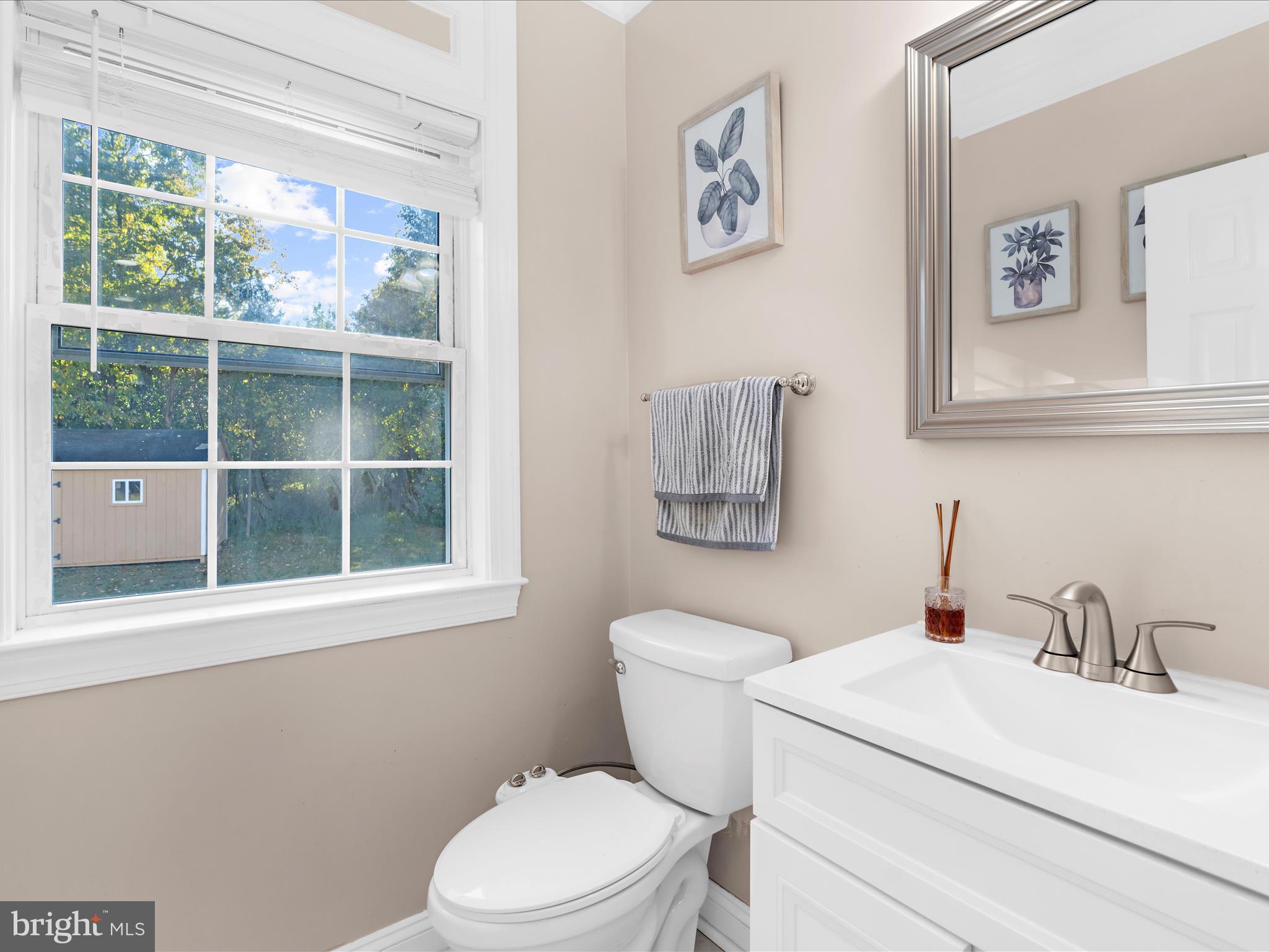 15533 Thompson Road Silver Spring, MD 20905 - Photo 52 of 76 a bathroom with a toilet a sink and a window