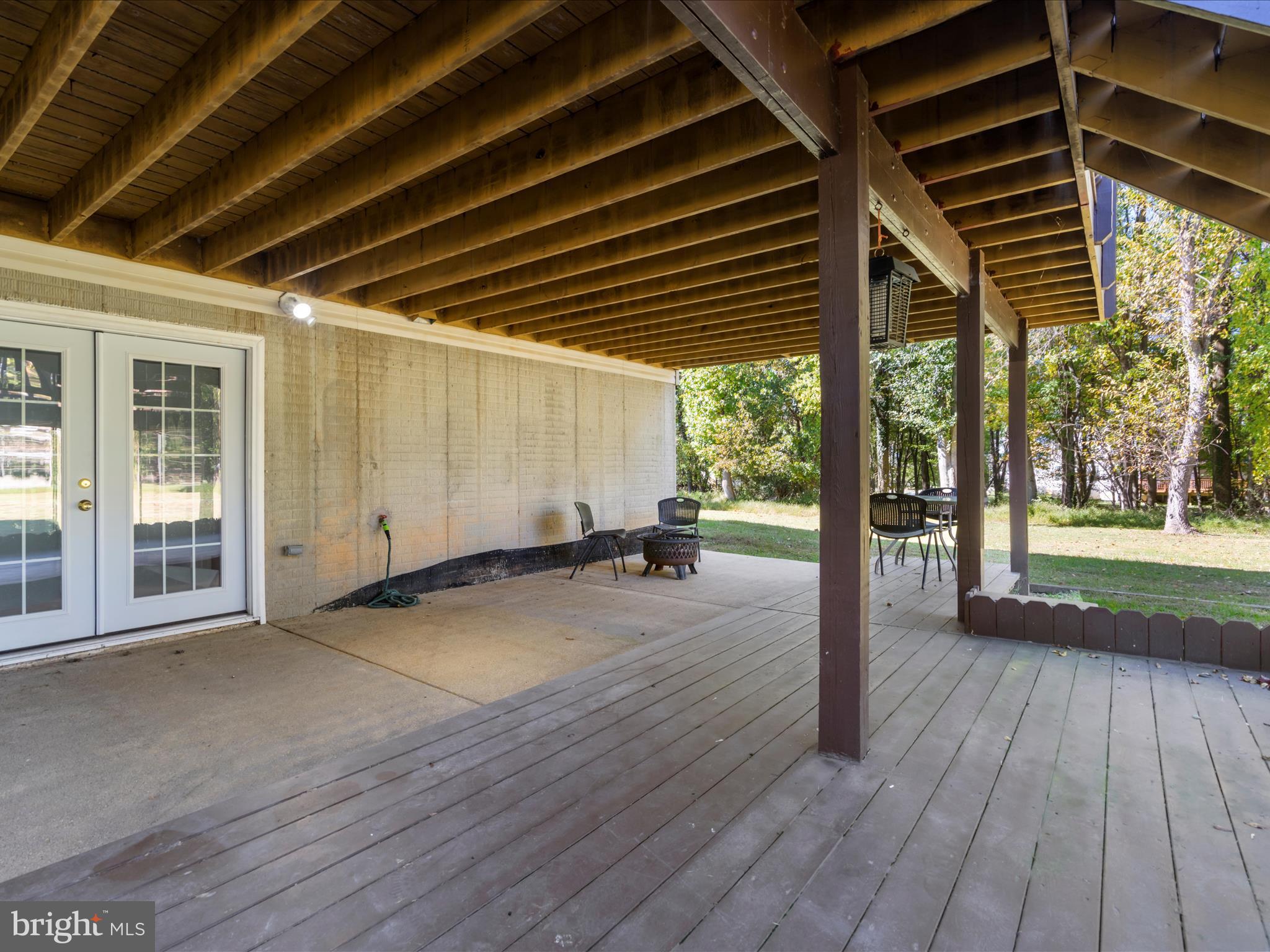 15533 Thompson Road Silver Spring, MD 20905 - Photo 58 of 76 a view of a porch with wooden floor and floor to ceiling window