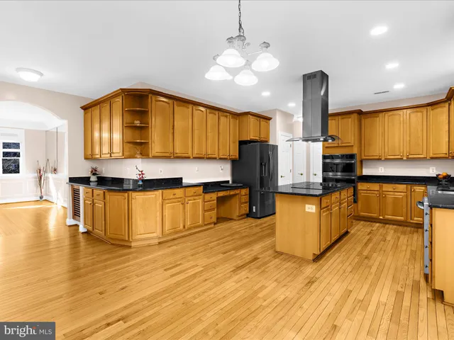 a kitchen with sink and large mirror