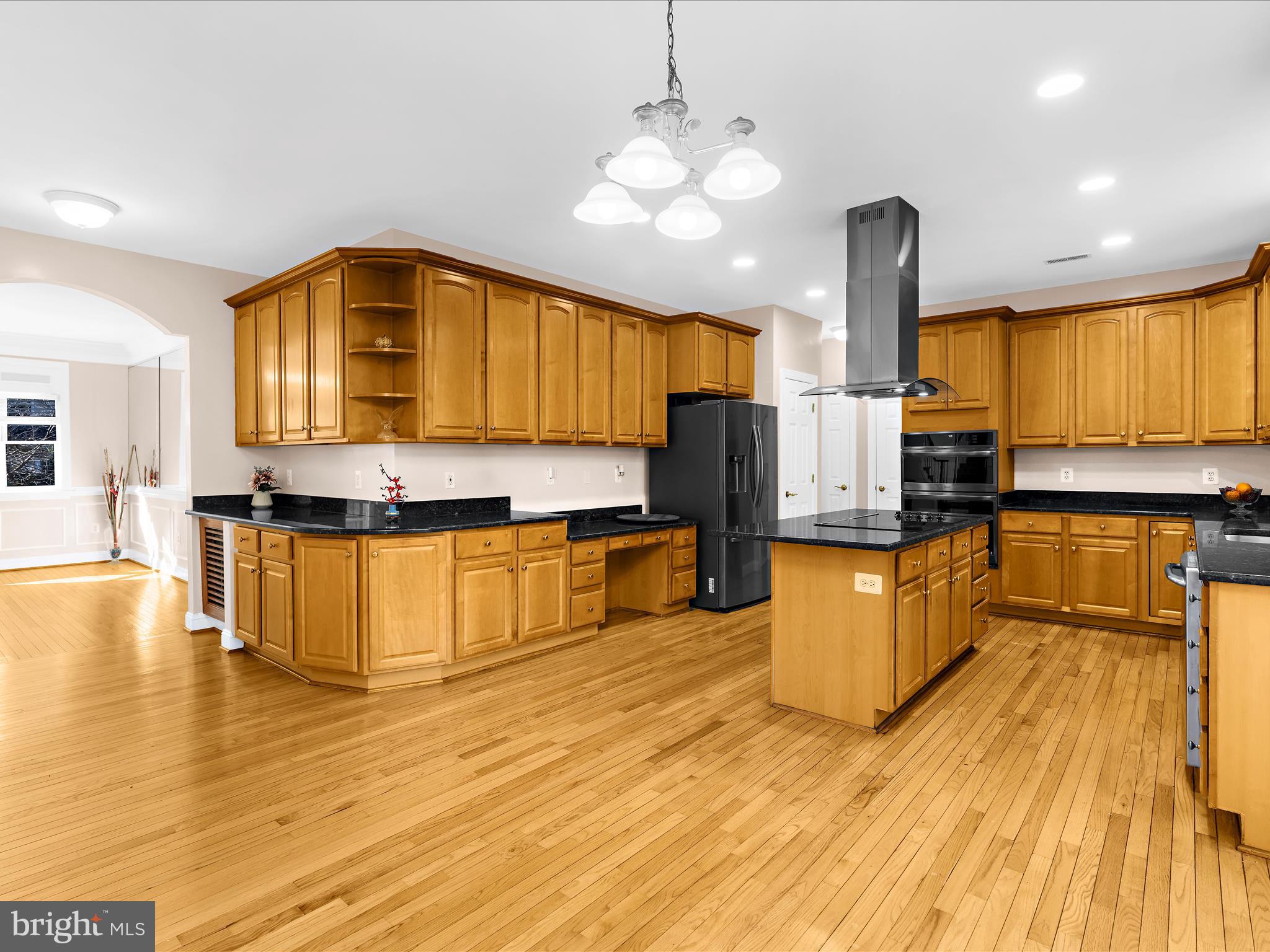 15533 Thompson Road Silver Spring, MD 20905 - Photo 9 of 76 a kitchen with stainless steel appliances kitchen island granite countertop a stove a sink and a wooden cabinets