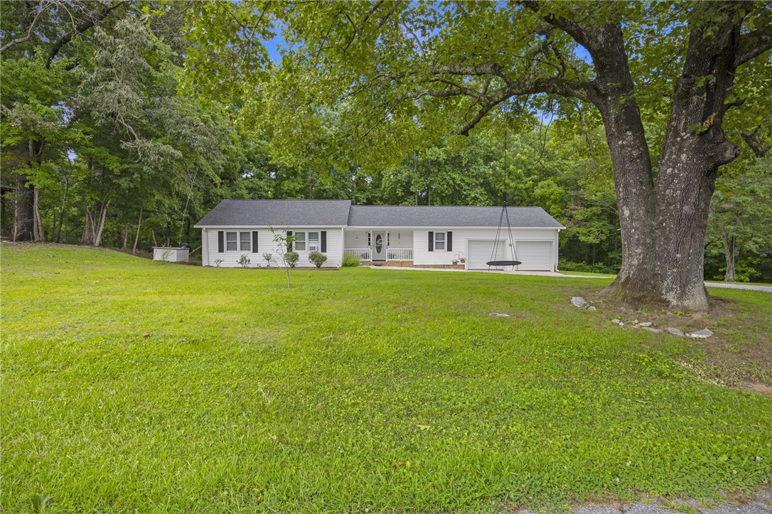250 Rockcrest Road Cleveland, SC 29635 - Photo 2 of 37 A classic ranch home nestled among mature trees offers serene living with ample green space.