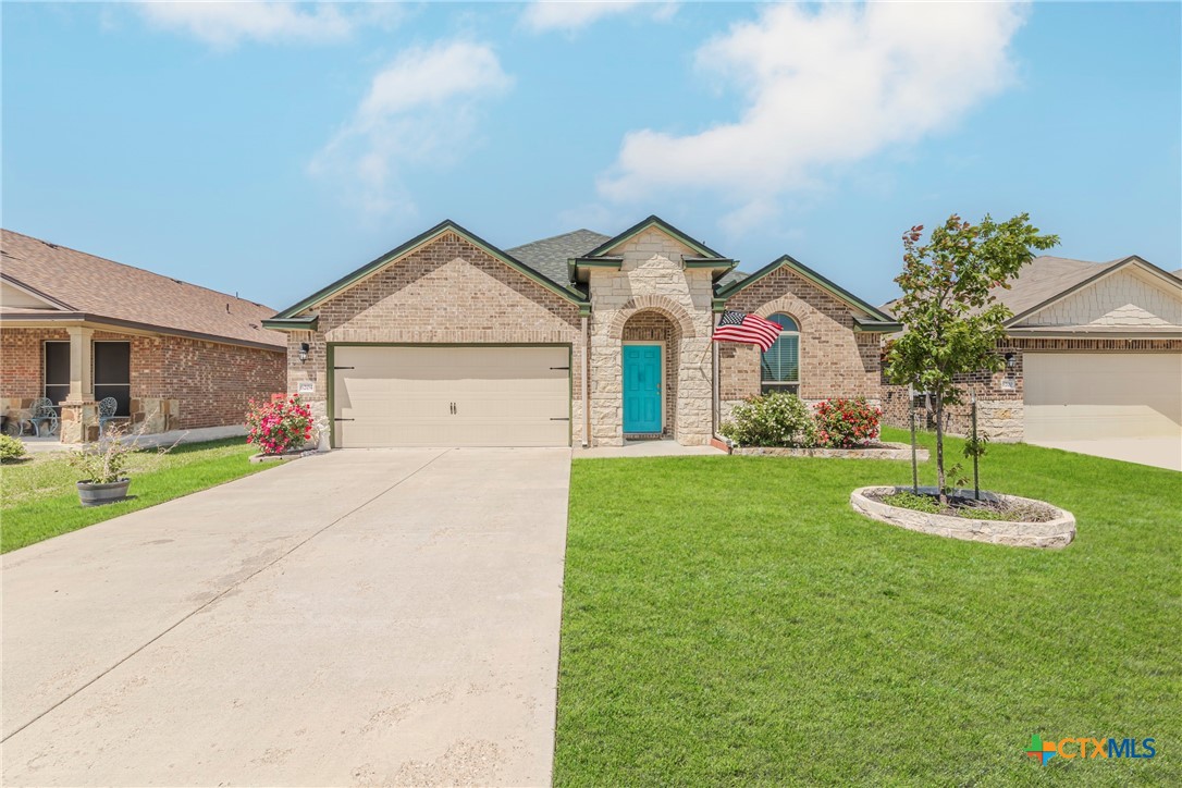 a front view of house with yard and green space