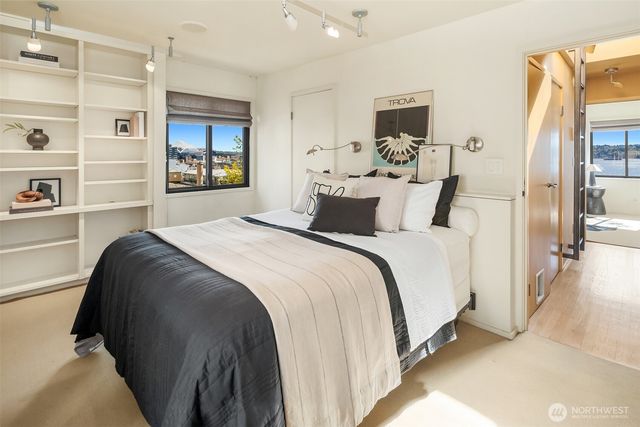 a bedroom with a bed and a window