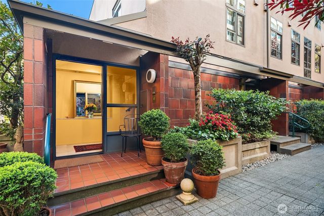 a view of a chair and table in the patio with a potted plant