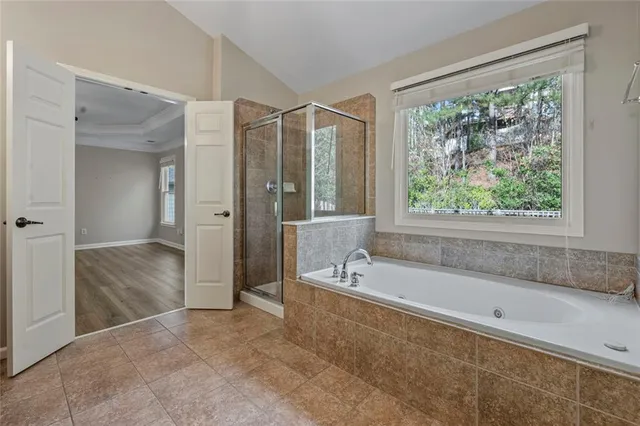 a spacious bathroom with a large tub shower and sink