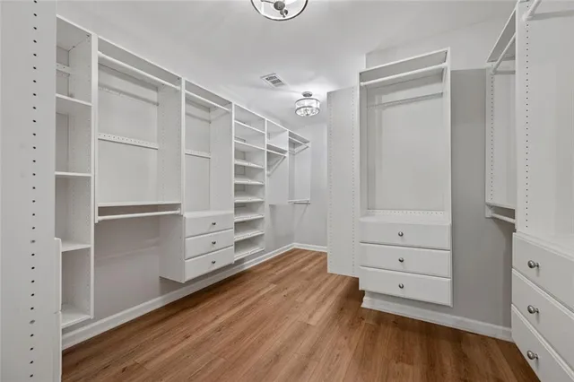 a view of walk in closet with empty racks
