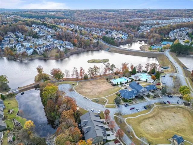 an aerial view of a house with a swimming pool yard and lake view