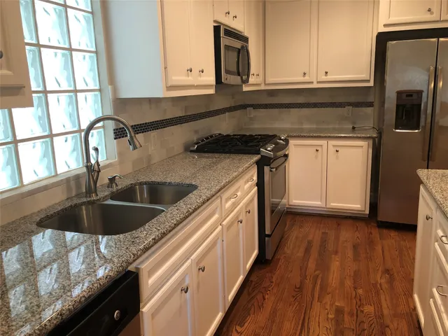a kitchen with a sink stove and cabinets