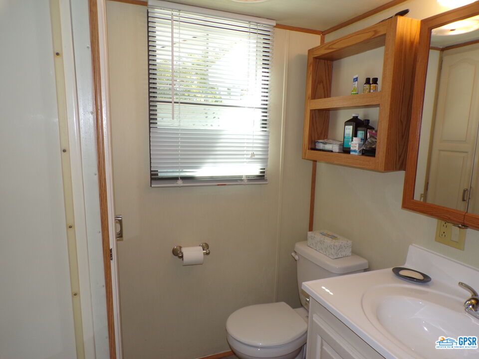 69801 Ramon Road, Unit 246 Cathedral City, CA 92234 - Photo 17 of 44 a white toilet sitting next to a bathroom sink