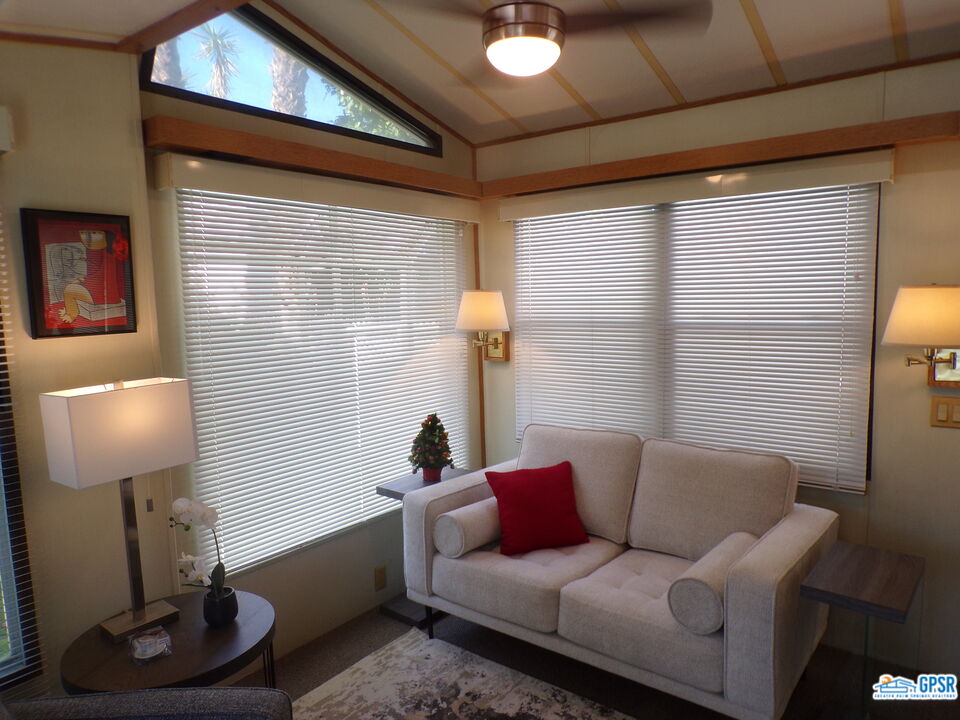 69801 Ramon Road, Unit 246 Cathedral City, CA 92234 - Photo 2 of 44 a living room with furniture and a lamp