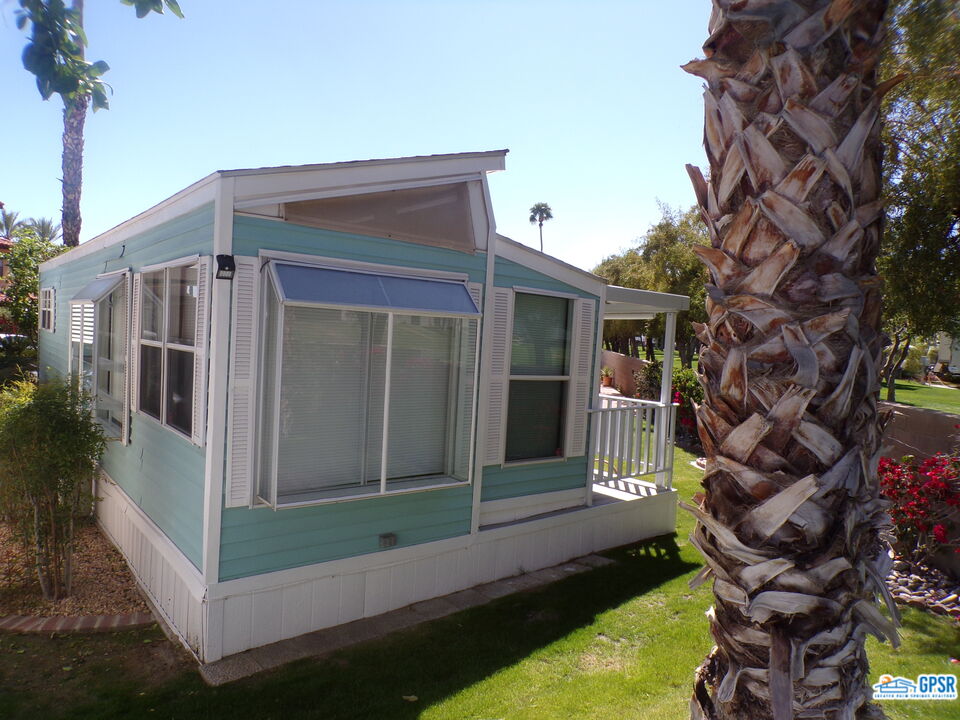 69801 Ramon Road, Unit 246 Cathedral City, CA 92234 - Photo 28 of 44 a backyard of a house with lots of green space