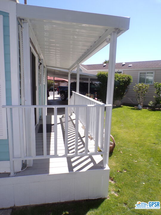 69801 Ramon Road, Unit 246 Cathedral City, CA 92234 - Photo 32 of 44 a view of a patio with lawn chairs floor to ceiling window and yard