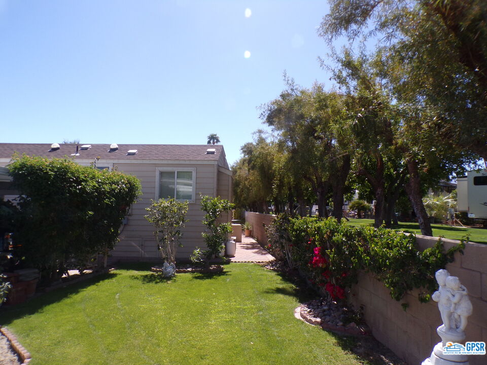 69801 Ramon Road, Unit 246 Cathedral City, CA 92234 - Photo 34 of 44 a view of a house with a backyard and a patio