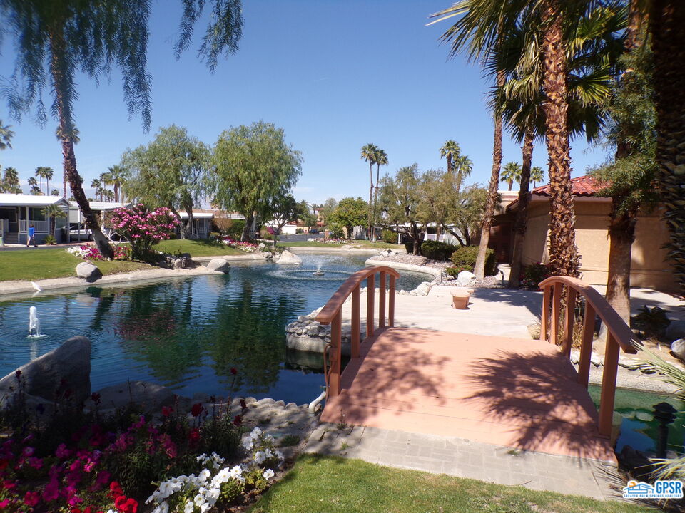 69801 Ramon Road, Unit 246 Cathedral City, CA 92234 - Photo 42 of 44 a view of a lake with a house in the background